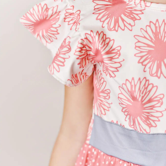Perfect for the spring and summertime. The combination of the coral, flower, cherry, and dot print sounds so cheerful and fun. The tiered flutter sleeve adds a beautiful touch to the dress and is sure to make your little girl look and feel amazing!